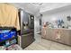 Functional kitchen with stainless steel refrigerator and wooden cabinets, providing a practical cooking space at 817 Hamilton St, Lebanon, IN 46052