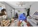 Cozy living room showing hardwood floors, ceiling fan, and eclectic furnishings, creating a cozy atmosphere at 817 Hamilton St, Lebanon, IN 46052