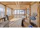 Enclosed wooden patio with a hammock, chair, and natural lighting, creating a relaxed outdoor space at 817 Hamilton St, Lebanon, IN 46052