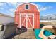 Red backyard shed with white trim and tongue and groove doors at 817 Hamilton St, Lebanon, IN 46052