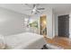 Comfortable bedroom featuring hardwood floors, dresser with TV, and natural light at 8401 N College Ave, Indianapolis, IN 46240