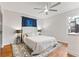 Serene bedroom with a neutral color palette, a ceiling fan, and hardwood floors at 8401 N College Ave, Indianapolis, IN 46240