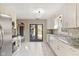 Stylish kitchen equipped with stainless steel appliances, stone counters, and ample storage space at 8401 N College Ave, Indianapolis, IN 46240