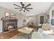 Spacious living room with hardwood floors, fireplace, and open layout to the kitchen at 8401 N College Ave, Indianapolis, IN 46240