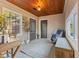 Cozy sunroom with wood ceiling, tile floors, and a comfortable seating area at 8401 N College Ave, Indianapolis, IN 46240