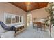 Bright sunroom with wooden desk, large windows, and access to the rest of the house at 8401 N College Ave, Indianapolis, IN 46240