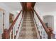 Elegant staircase with a carpet runner and white railing leads to the upper level at 8452 Sunningdale Blvd, Indianapolis, IN 46234