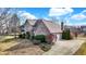 Aerial view of brick home showcasing landscaping, driveway, and well-maintained exterior at 897 Copperwood Dr, Carmel, IN 46033