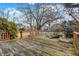 Wood deck with orange railing and a wooden base; lush trees and bushes surround the deck at 897 Copperwood Dr, Carmel, IN 46033