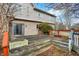 Rear view of a brick house with a weathered, multi-tiered wooden deck and railings at 897 Copperwood Dr, Carmel, IN 46033
