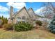 Back exterior view of a brick and siding house, including back deck and manicured shrubs in yard at 897 Copperwood Dr, Carmel, IN 46033