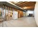 Spacious unfinished basement with exposed ductwork and a large refrigerator, ready for customization at 897 Copperwood Dr, Carmel, IN 46033