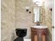 Powder room featuring beautiful marble walls, an ornate vanity, and classic fixtures at 897 Copperwood Dr, Carmel, IN 46033