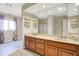 Bathroom featuring double sinks with wood cabinetry, large mirror, and natural light at 897 Copperwood Dr, Carmel, IN 46033