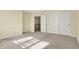 Bright bedroom featuring double closets, a view of the staircase, and neutral carpeting at 897 Copperwood Dr, Carmel, IN 46033