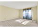 Empty bedroom with neutral walls, carpet, and a window covered with sheer curtains at 897 Copperwood Dr, Carmel, IN 46033