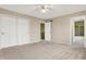 Spacious bedroom with neutral carpet, double closet, and an ensuite bathroom at 897 Copperwood Dr, Carmel, IN 46033