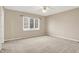 This bedroom features a ceiling fan, neutral paint, and a large window with blinds at 897 Copperwood Dr, Carmel, IN 46033