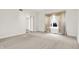 Well-lit room with neutral carpet, large window and doorway at 897 Copperwood Dr, Carmel, IN 46033
