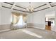 Formal dining room features elegant coffered ceilings and chandelier lighting at 897 Copperwood Dr, Carmel, IN 46033