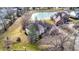 Beautiful, expansive home featuring brick exterior, mature trees, and waterfront views of the nearby pond at 897 Copperwood Dr, Carmel, IN 46033