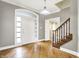 Bright foyer featuring hardwood floors, staircase, and decorative front door at 897 Copperwood Dr, Carmel, IN 46033