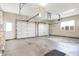 Two-car garage with white doors, concrete floor, and plenty of space for vehicles at 897 Copperwood Dr, Carmel, IN 46033