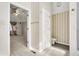 Hallway leading to bedroom and bathroom with neutral striped wallpaper at 897 Copperwood Dr, Carmel, IN 46033