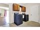 Laundry room equipped with modern washer and dryer and cabinets for storage at 897 Copperwood Dr, Carmel, IN 46033