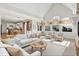 Spacious living room filled with natural light, featuring vaulted ceilings and an open layout into the kitchen at 897 Copperwood Dr, Carmel, IN 46033