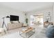 Bright living room featuring hardwood floors, neutral paint colors, and an open floor plan to the dining room at 897 Copperwood Dr, Carmel, IN 46033