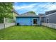 Large backyard with blue siding, green siding, gray siding, and white picket fence at 912 Harlan St, Indianapolis, IN 46203