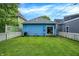 Backyard featuring a well-maintained lawn, privacy fence, and blue home exterior, creating an inviting outdoor space at 912 Harlan St, Indianapolis, IN 46203