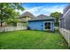 Spacious backyard featuring well-maintained lawn, privacy fence, and exterior view of the home at 912 Harlan St, Indianapolis, IN 46203