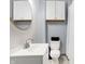 Clean bathroom features a white sink vanity, modern faucet, matching toilet, and white wall-mounted cabinet at 912 Harlan St, Indianapolis, IN 46203