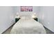 Cozy bedroom features matching green nightstands, lamps, and decorative artwork over the bed with fluffy comforter at 912 Harlan St, Indianapolis, IN 46203