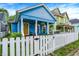 Charming blue two-story home with a white picket fence and inviting curb appeal at 912 Harlan St, Indianapolis, IN 46203