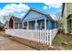 Charming blue home with white picket fence and inviting front porch at 912 Harlan St, Indianapolis, IN 46203