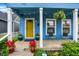 Inviting front porch with seating, colorful potted plants, and hanging ferns creating a warm welcome at 912 Harlan St, Indianapolis, IN 46203