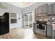 Modern kitchen with stainless steel appliances, gray cabinets, and a mosaic backsplash at 912 Harlan St, Indianapolis, IN 46203
