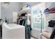 Well-organized laundry room features bright window, shelving, and laundry appliances, providing a functional space at 912 Harlan St, Indianapolis, IN 46203