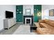 Inviting living room featuring a fireplace, tv and plush leather sofa at 912 Harlan St, Indianapolis, IN 46203
