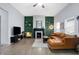 Spacious living room featuring hard wood floors, fireplace and ceiling fan at 912 Harlan St, Indianapolis, IN 46203