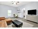 Bright living room features a brown leather sectional, modern decor, and TV console at 912 Harlan St, Indianapolis, IN 46203