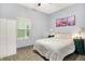 A cozy bedroom featuring a soft white bed, natural light, and stylish decor at 912 Harlan St, Indianapolis, IN 46203