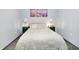 A cozy bedroom featuring a soft white bed, decorative lamps, and stylish decor at 912 Harlan St, Indianapolis, IN 46203