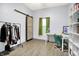 Bright office featuring hardwood floors, a sliding barn door, and a white desk with a comfortable chair at 912 Harlan St, Indianapolis, IN 46203