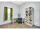 Office space featuring a desk, a stylish chair, built-in bookcases, and a window with natural light at 912 Harlan St, Indianapolis, IN 46203