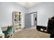 Bright home office featuring hardwood floors, a modern desk, a white bookcase, and view into adjacent room at 912 Harlan St, Indianapolis, IN 46203