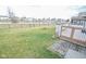 Spacious backyard featuring lush green grass, a calming pond, and convenient deck access at 10708 Inspiration Dr, Indianapolis, IN 46259